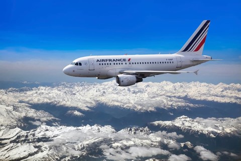 Air France Airbus A318-111 in flight over mountains