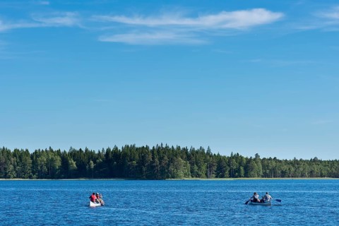Two canoes with canoeists on Lake Asnen