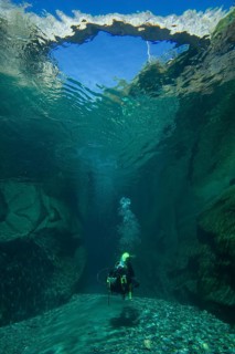 Scuba diver diving below the bridge of Ponte dei Salti