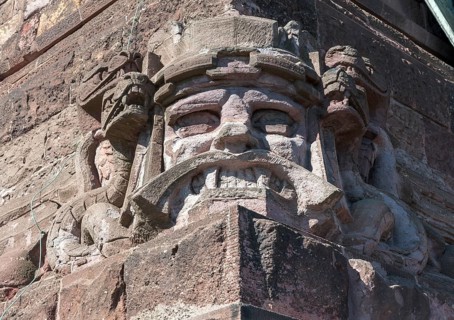 Snarling sandstone head mask and snakes