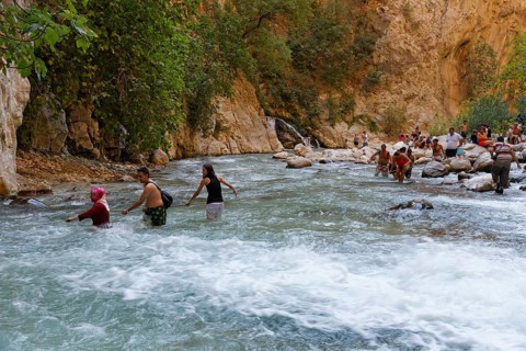 Tourists crossing the river