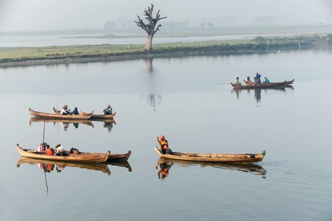 Fishermen in their boats in the morning light