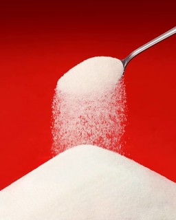 Sugar falling from a spoon