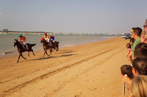 Horse race at the beach of Sanlucar de Barrameda at the Guadalquivir river mouth