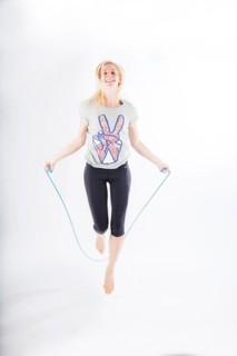 Woman in sportswear jumping rope