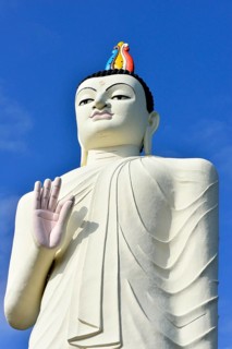 Large Buddha figure in front of a monastery near Sigiriya