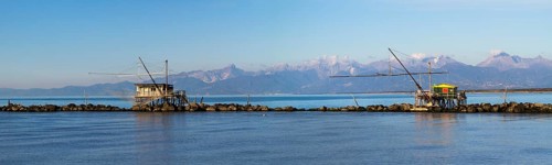 Fisherman's houses with nets over the sea in Marina di Pisa
