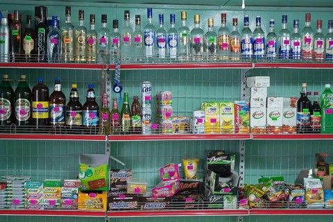 Alcoholic beverages and sweets on sale at a village market