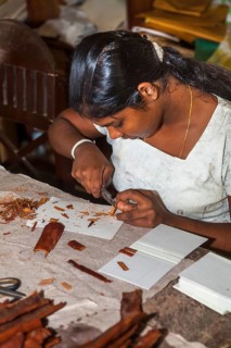 Young woman making wood jewelry