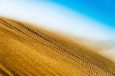 Sand blowing in a storm over the crest of a dune