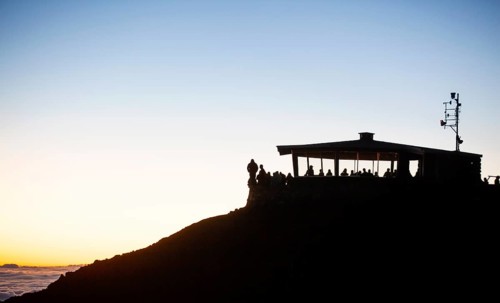 Tourists awaiting the sunrise on the summit of the Haleakala volcano