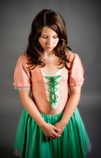 Girl wearing an old-fashioned dress looking sad
