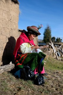 Young woman embroidering a cloth with traditional patterns