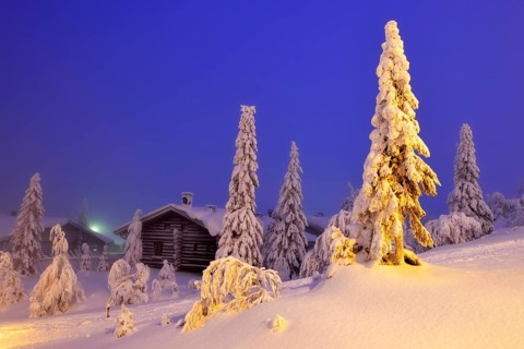 Finnish log cabin in the snow-covered landscape
