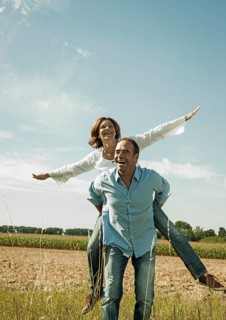 Man giving a woman a piggyback ride
