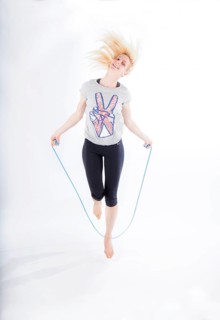 Woman in sportswear jumping rope