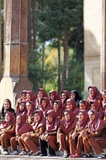 Iranian girls posing for a class photo wearing uniforms