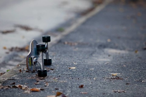 Skateboard lying on a wet street