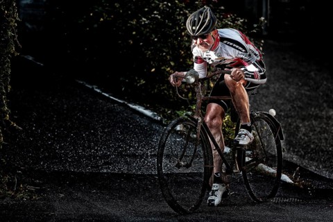 Racing cyclist riding on an old bicycle