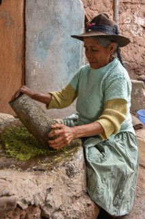 Local woman mortaring herbs