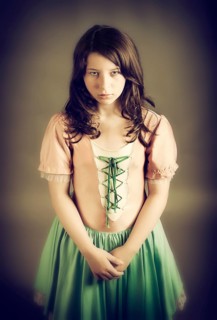 Girl wearing an old-fashioned dress looking sad