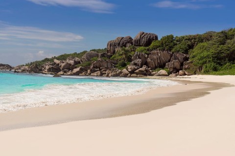 Sandy beach with the rock formations typical for the Seychelles