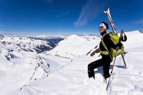Winter sportswoman on a mountain peak
