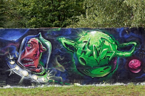 Alien shooting towards a green planet