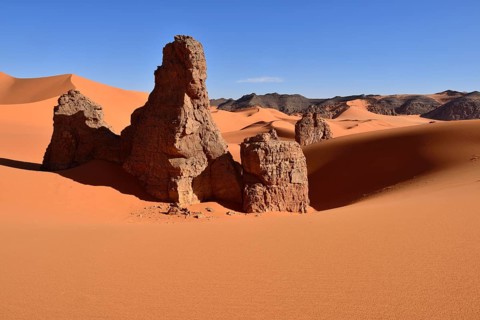 Rock towers in the sand dunes of Tin Merzouga