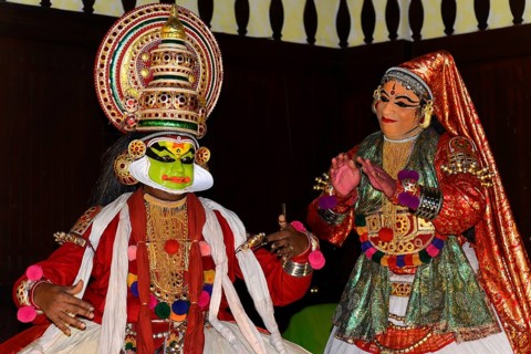 Fully made-up and costumed Kathakali dancers during a performance