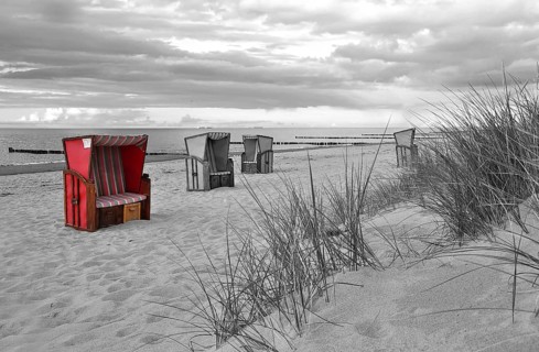 Roofed wicker beach chairs on the beach