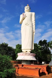 Giant Buddha statue in front of a monastery