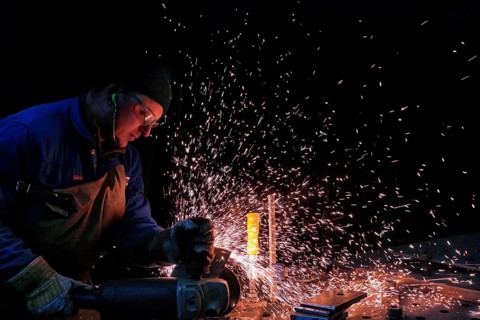 Man grinding a piece of iron