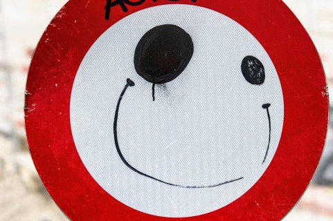 Road sign with a painted face