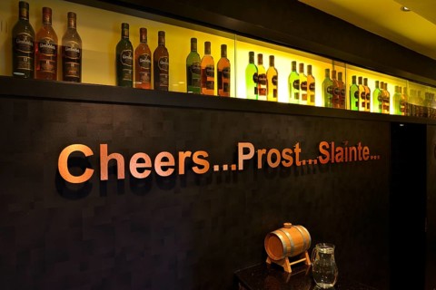 Whiskey bottles and lettering 'cheers