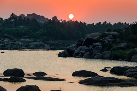 Sunset over Tungabhadra river and a part of the ruins of the former Vijayanagara Empire