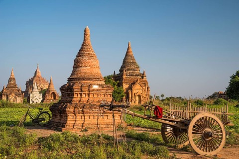 Cart and a bicycle in front of pagoda