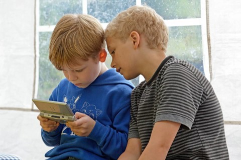 Two boys playing Nintendo