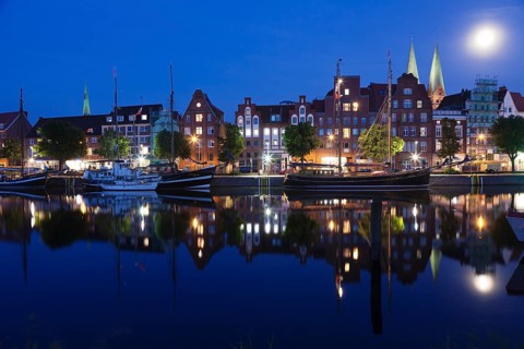 Trave river and the historic centre at full moon