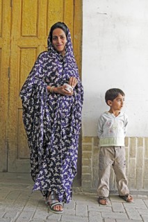Woman in modern chador with son