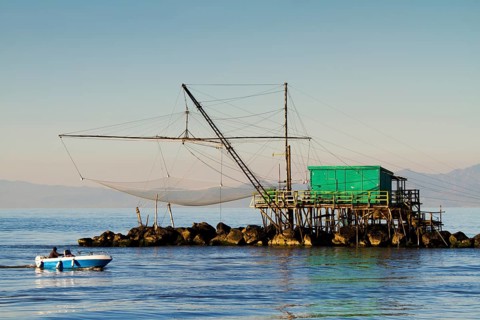 Fisherman's house with a net over the sea in Marina di Pisa