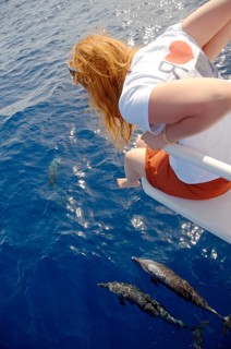 Red-haired woman looking at dolphins
