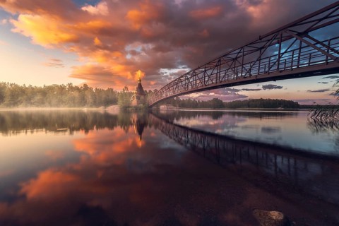 Bridge and Church of St. Andrew at Vuoksi River during sunset