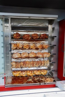 Market stall with a chicken grill and fried chicken