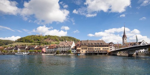 Townscape on the bank of the Rhine River with a boat landing and Burg Hohenklingen Castle
