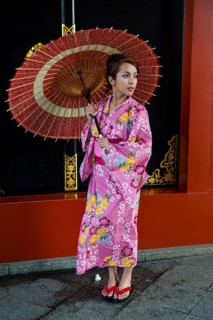 Young woman in kimono and with oil-paper umbrella