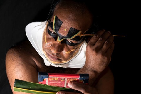 Katakali artist applying the makeup of the Shiva character