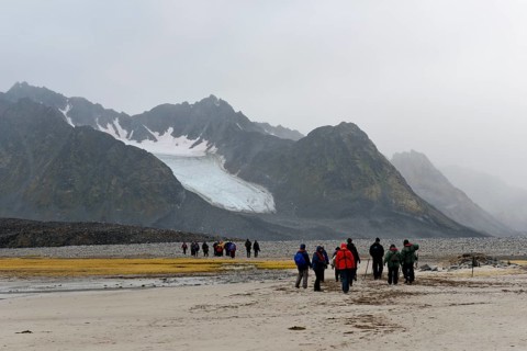 Tourists hiking at Magdalene Fjord