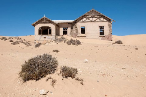 House of a former diamond miners settlement that is slowly covered by the sand of the Namib Desert