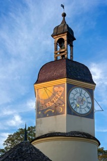 Sundial and a mechanical clock in the clock tower with a time shift in the summertime
